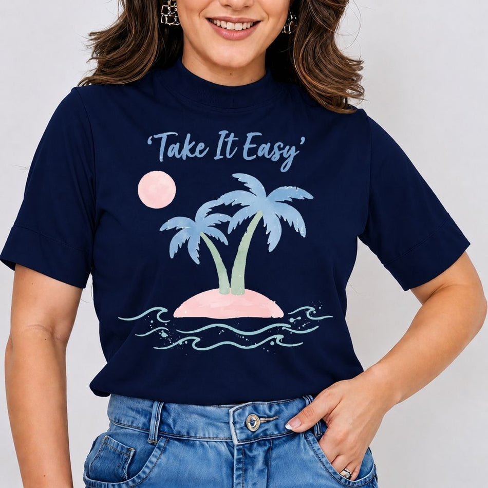 A woman wearing a navy blue short-sleeve t-shirt with a graphic of a tropical island, palm trees, and the text 'Take It Easy' in white script. She is also wearing blue denim jeans against a plain light gray background.