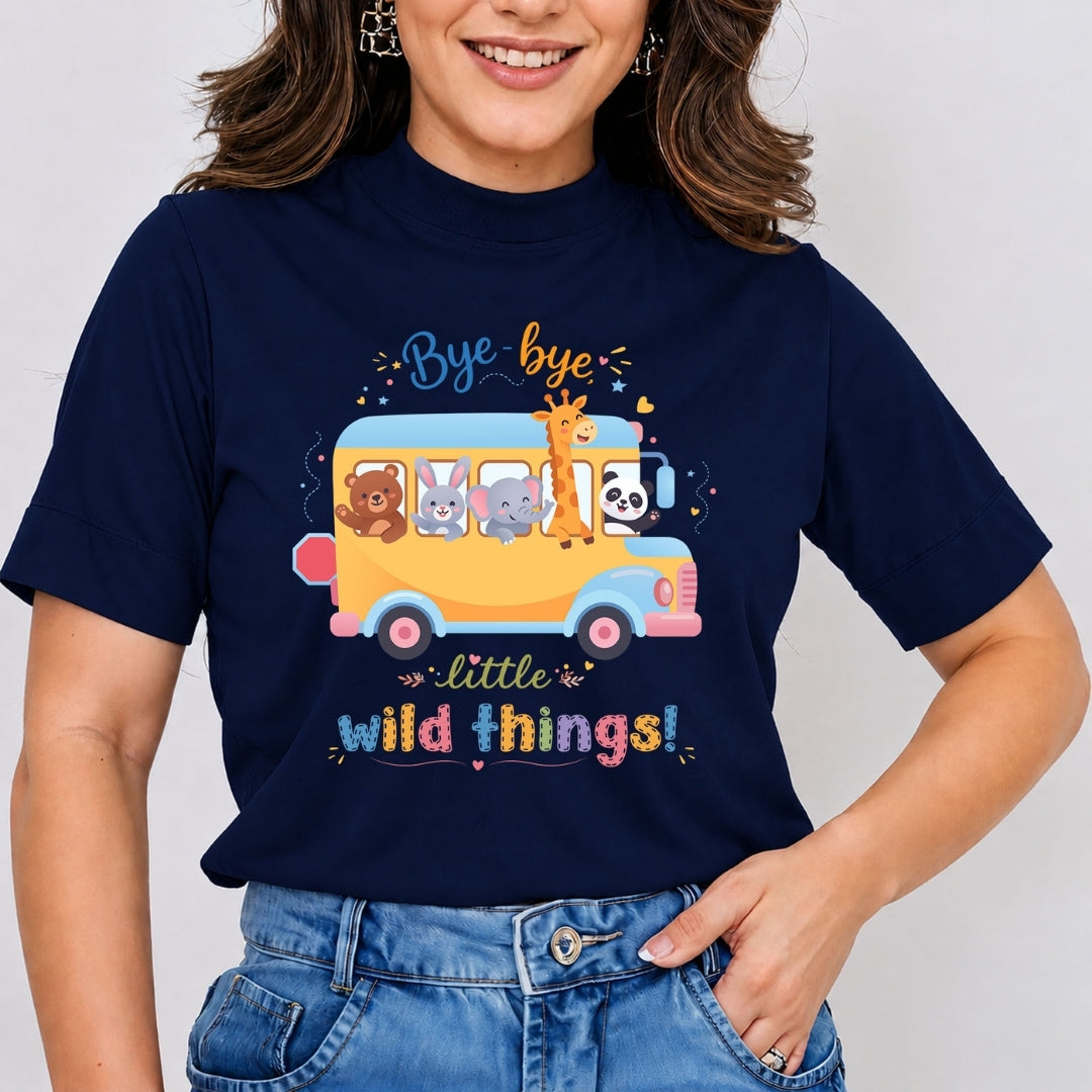 A person wearing a navy blue t-shirt with a school bus graphic filled with cartoon animals and the text "Bye-bye little wild things!"