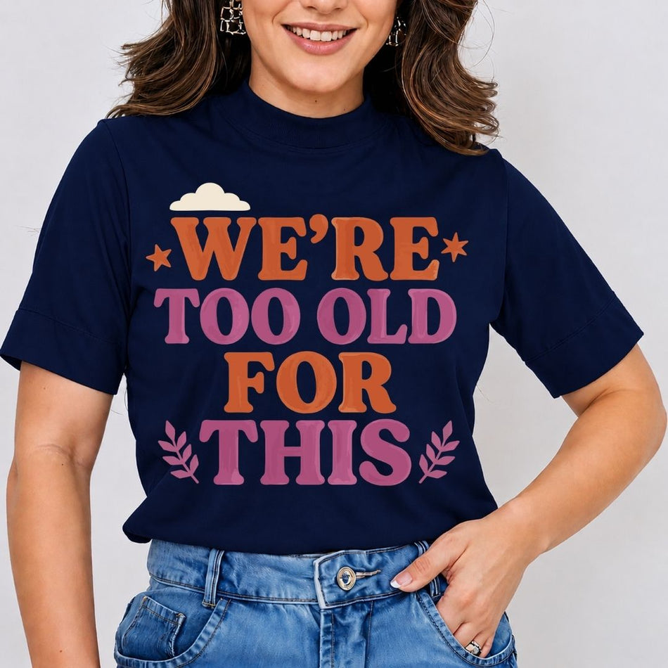 A smiling woman wearing a navy blue mock-neck t-shirt featuring a retro "Tequila Baby" text graphic with a green liquor bottle printed on the front.