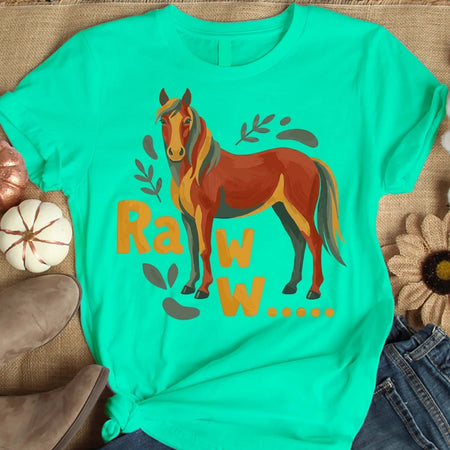 Turquoise t-shirt with a horse graphic and 'Rawr' text on a textured surface.