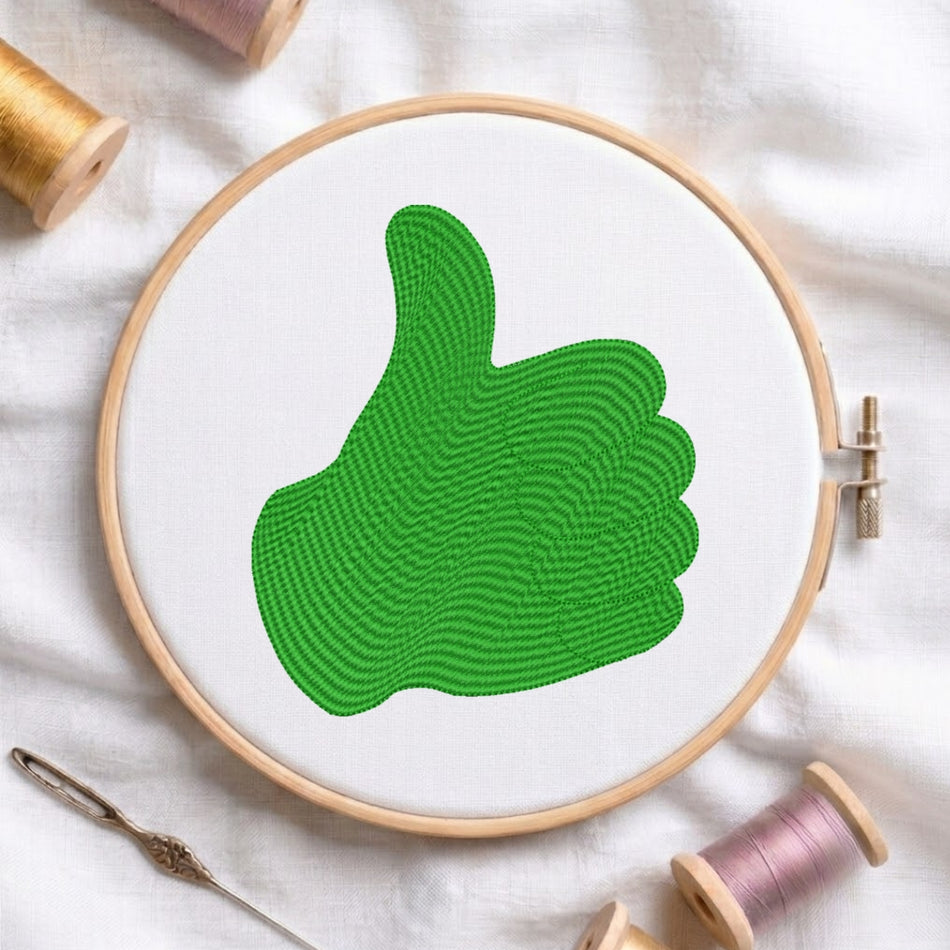 Embroidery hoop with green thumb up design on a white fabric background