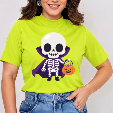 A woman wearing a bright lime green mock-neck t-shirt with a cartoon graphic of a skeleton vampire holding a pumpkin candy basket, paired with blue jeans.