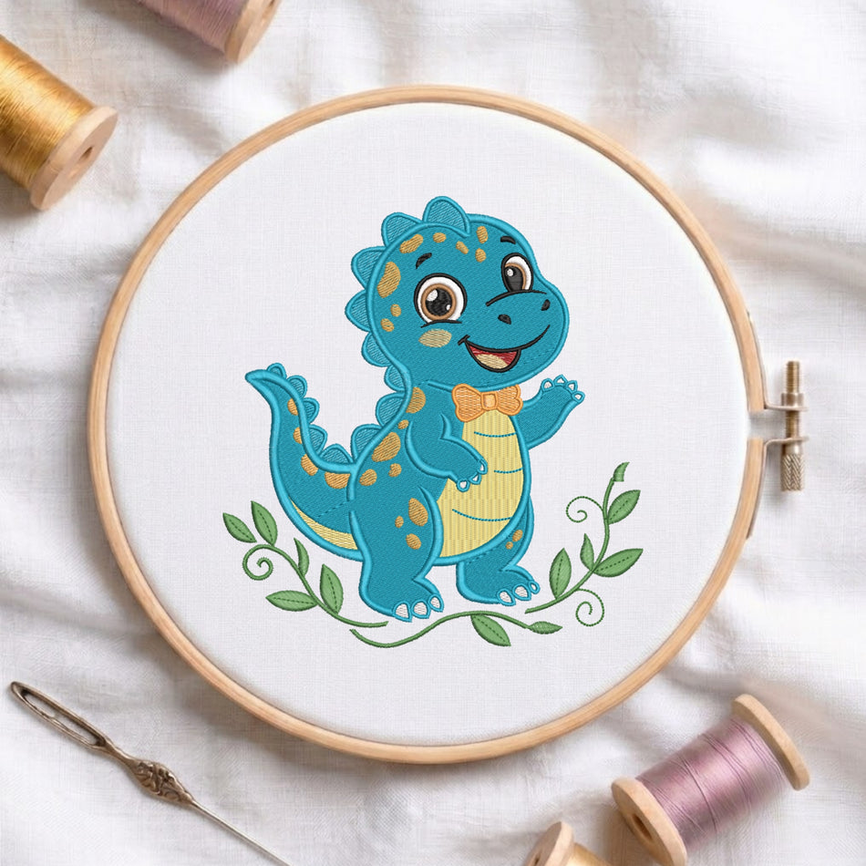 A wooden embroidery hoop holding white fabric with a colorful cartoon dinosaur design. The hoop is styled on a white fabric background with spools of thread and a needle nearby.
