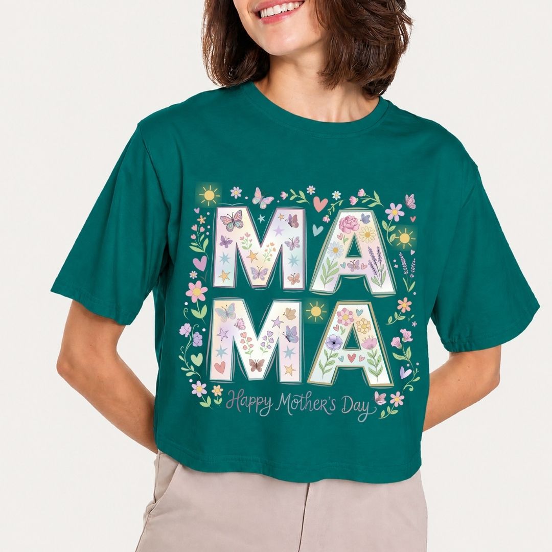 Person wearing a teal t-shirt with 'MAMA' and floral design, on a plain background