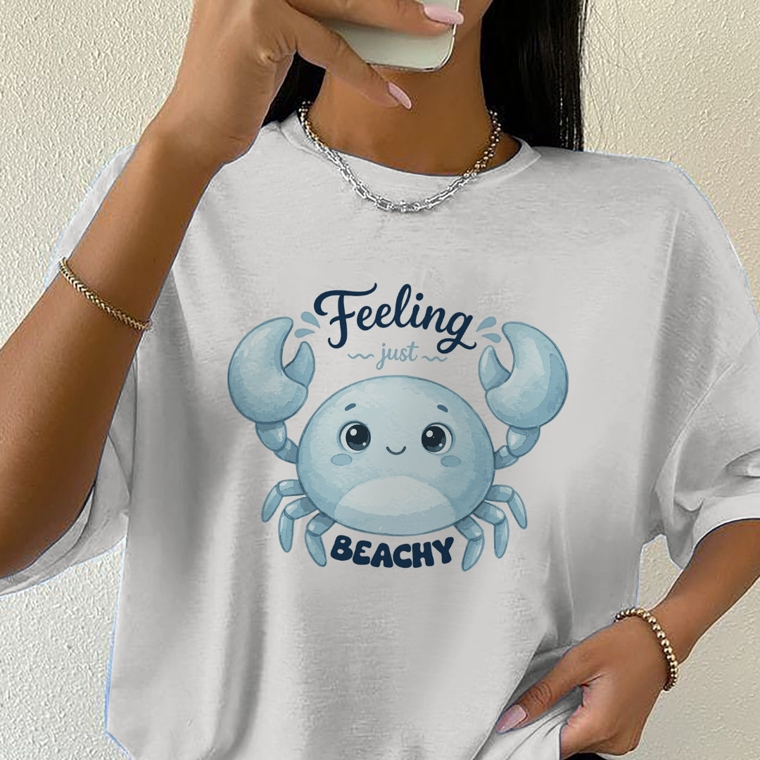 Person wearing a white t-shirt with a blue crab graphic and text.