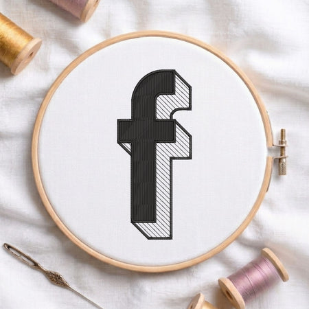 An embroidered 3D block lowercase letter "f" with striped shading texture, stitched inside a wooden hoop on white fabric with sewing threads.