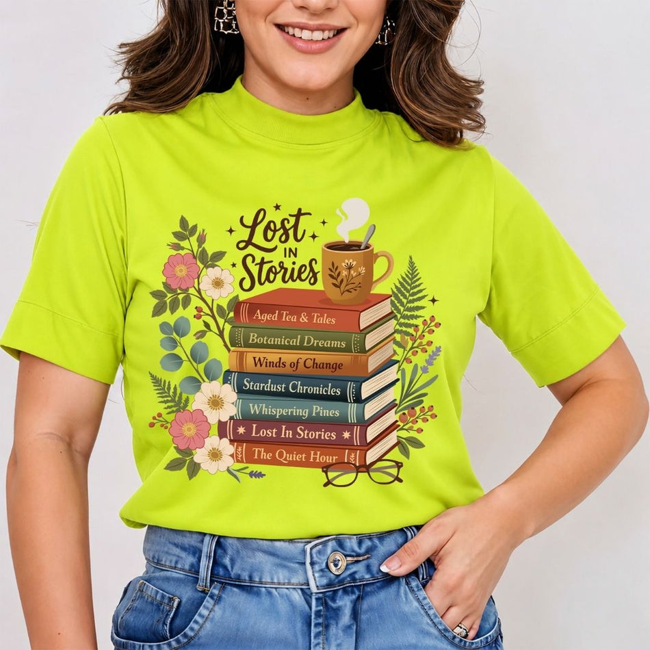 A woman wearing a bright lime green mock-neck t-shirt with a 'Lost in Stories' book-themed graphic print, paired with blue jeans.