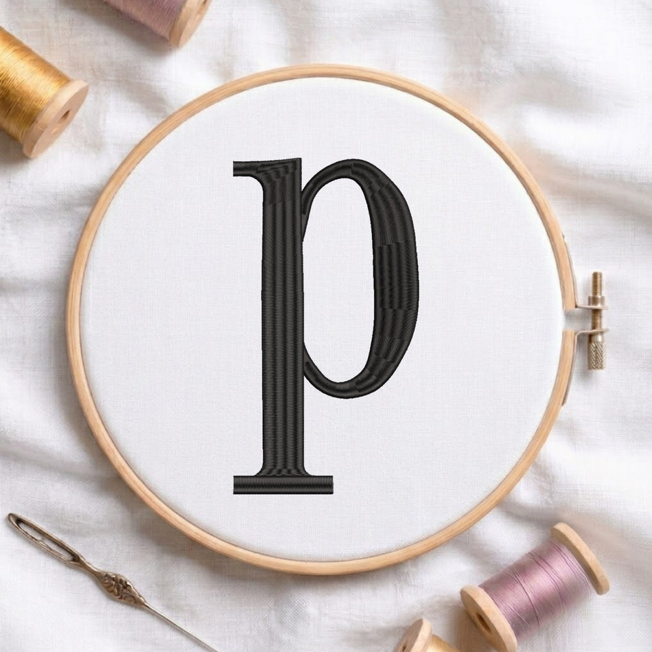 A wooden embroidery hoop holding white fabric with a large black letter 'p' stitched in the center, surrounded by spools of thread and a needle on a white fabric background.