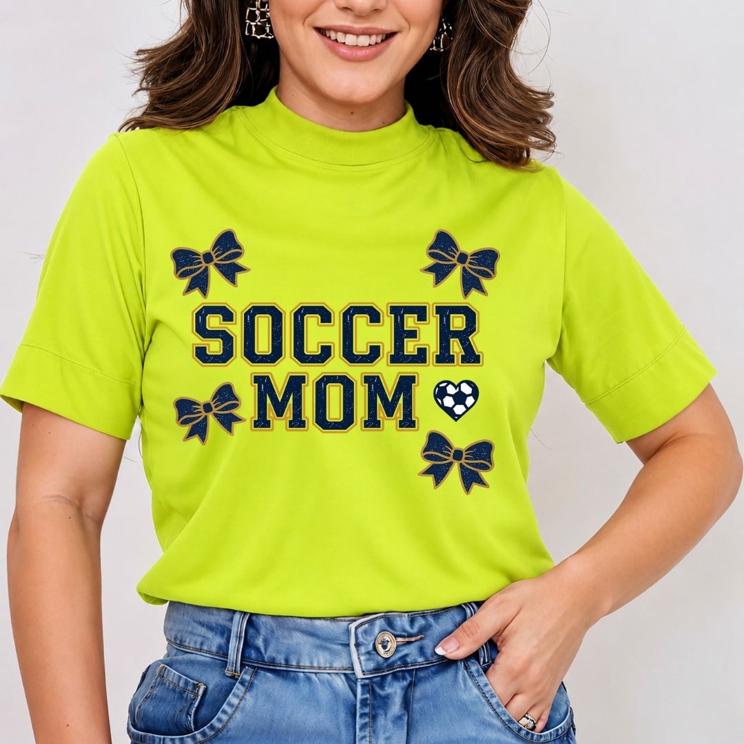 Person wearing a bright green 'Soccer Mom' t-shirt with decorative elements on a plain background