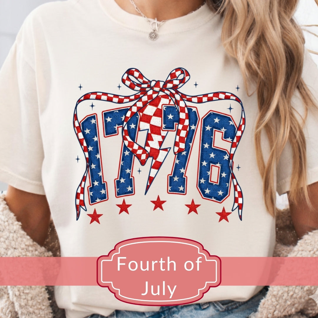 White t-shirt with '1776' design featuring stars and a bow, labeled 'Fourth of July'.