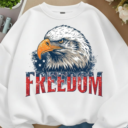 White sweatshirt with an eagle graphic and 'FREEDOM' text on a neutral background