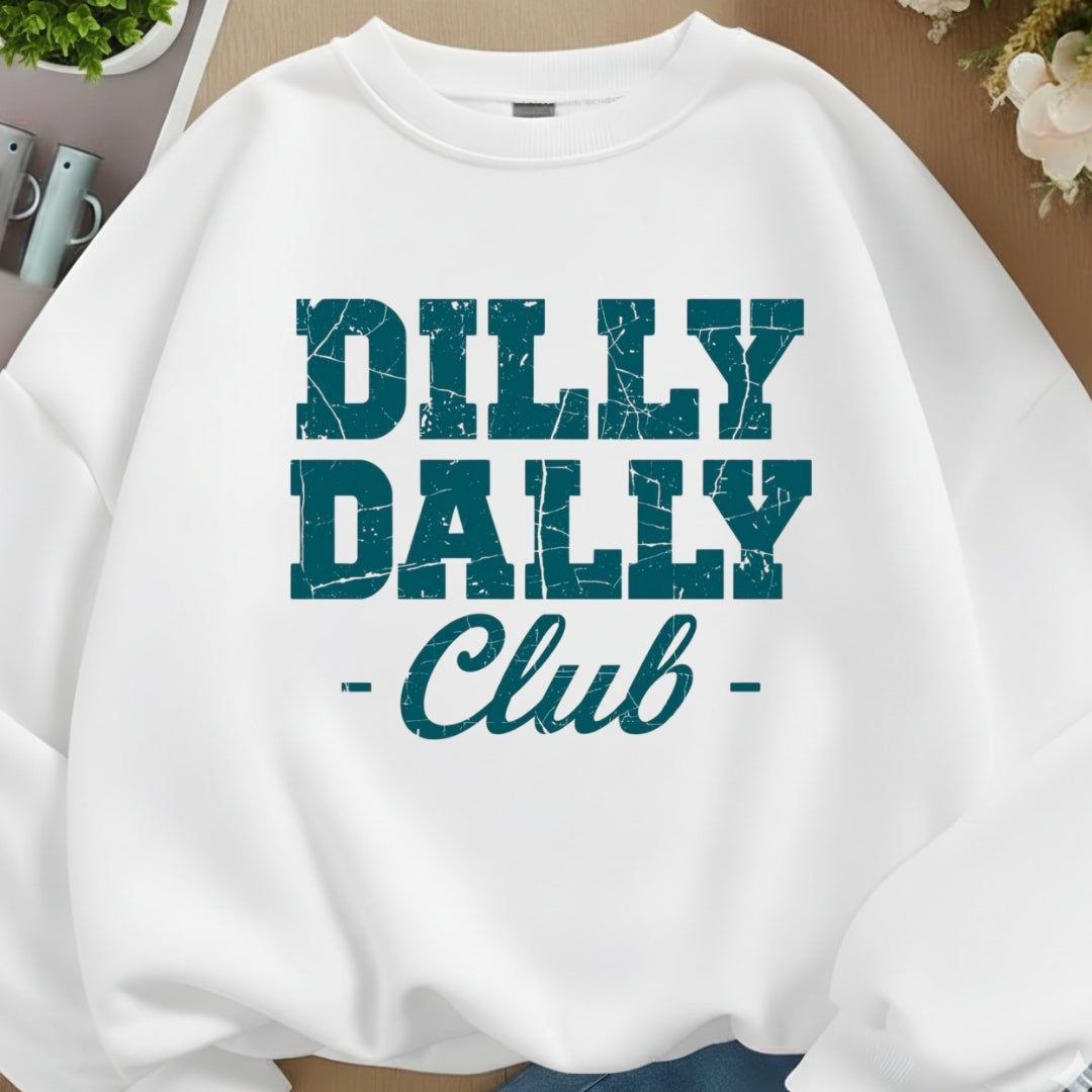 White sweatshirt with 'Dilly Dally Club' text in teal on a neutral background