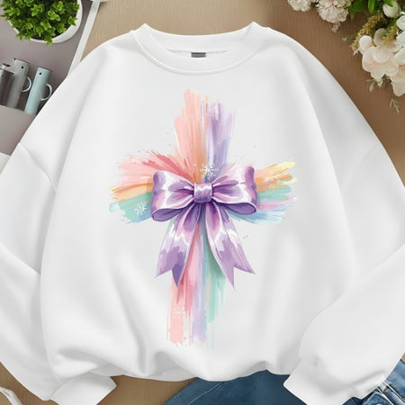 White sweatshirt with a colorful bow design on a neutral background