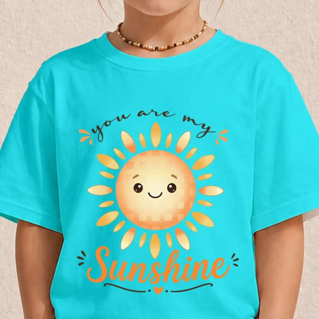 A person wearing a bright turquoise t-shirt featuring a happy cartoon sun graphic and the text "you are my Sunshine".