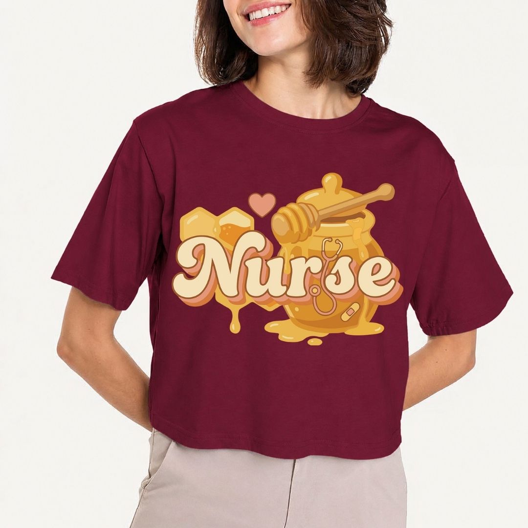 Person wearing a maroon t-shirt with 'Nurse' design featuring a honeycomb and dipper.