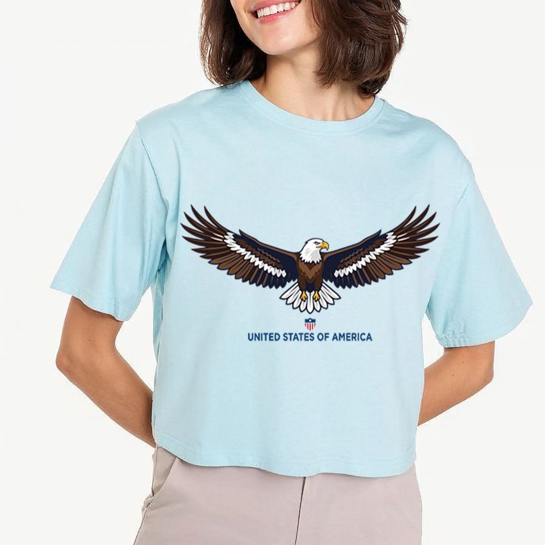Person wearing a light blue t-shirt with an eagle graphic and 'United States of America' text.