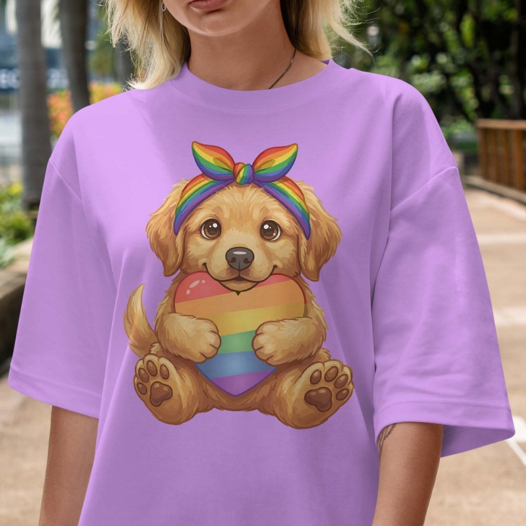 Person wearing a purple t-shirt with a colorful dog graphic holding a rainbow heart.