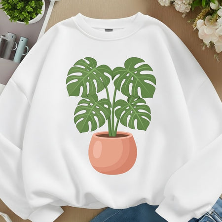White sweatshirt mockup featuring a cute potted Monstera plant illustration on the front.