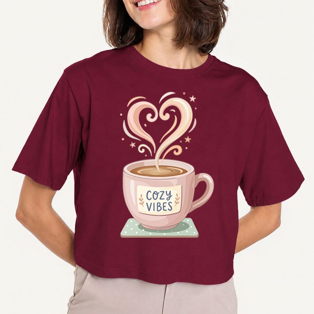 Person wearing a maroon t-shirt with a coffee cup graphic and 'Cozy Vibes' text.