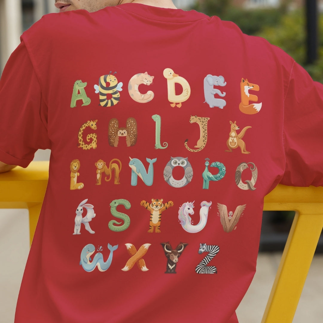 Back view of a person wearing a bright red t-shirt showcasing the educational A-Z animal alphabet graphic.