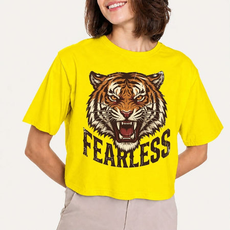 Person wearing a yellow t-shirt with a tiger graphic and 'FEARLESS' text on a plain background