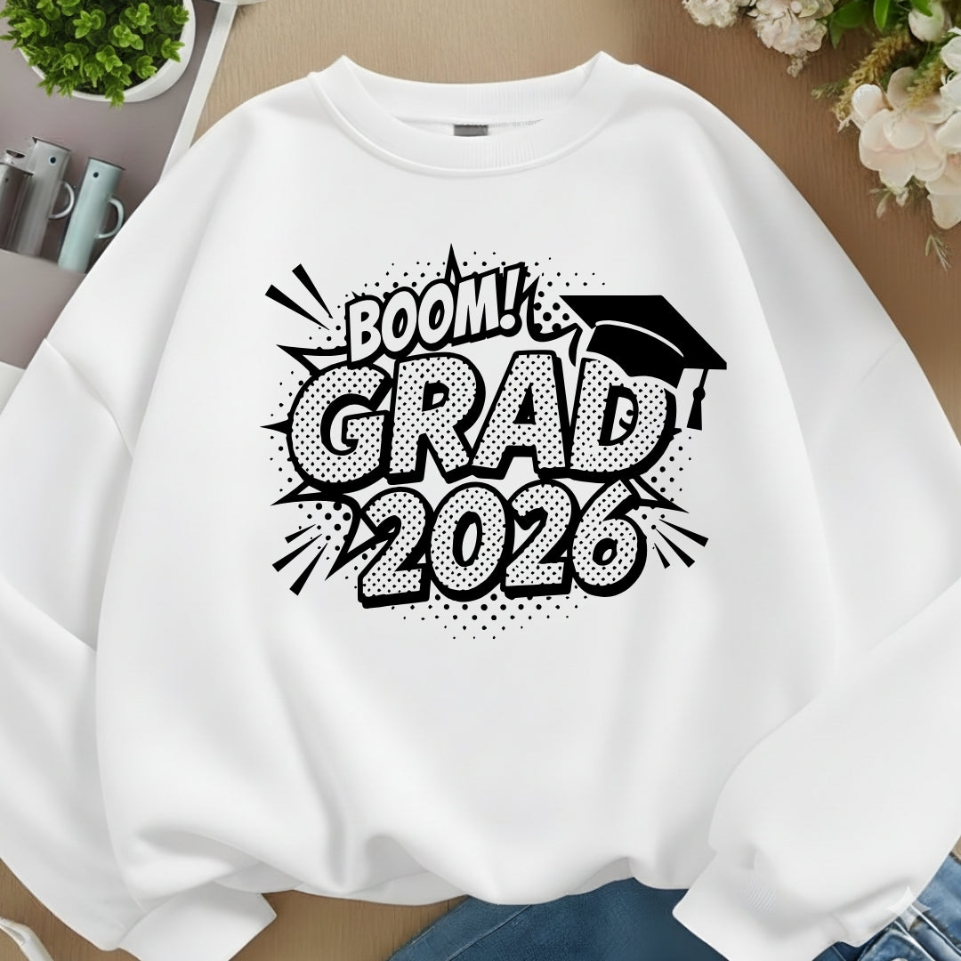 White sweatshirt with 'BOOM! GRAD 2026' text and graduation cap design on a neutral background.