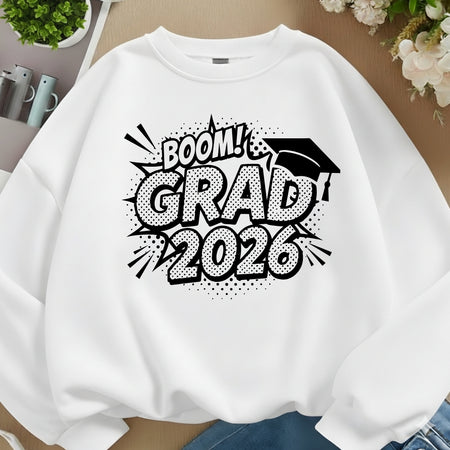 White sweatshirt with 'BOOM! GRAD 2026' text and graduation cap design on a neutral background.