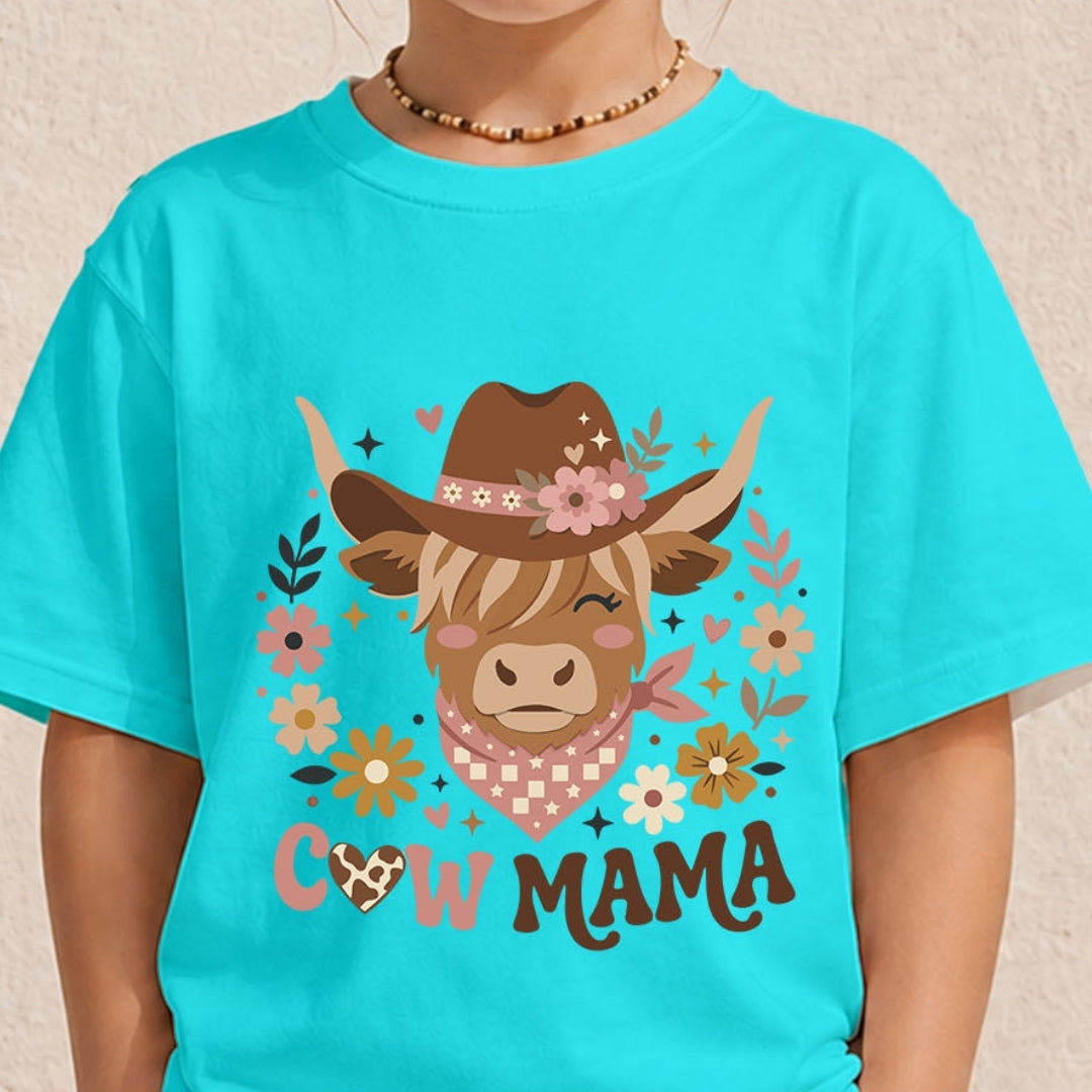 A child wearing a bright turquoise short-sleeve T-shirt with a large western cow graphic on the front. The graphic shows a brown cowboy hat, pink flowers, a pink-and-white checkered bandana, and the words “COW MAMA.