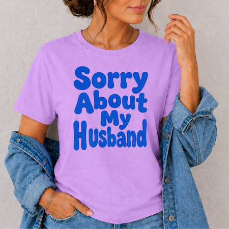 Person wearing a purple t-shirt with 'Sorry About My Husband' text.
