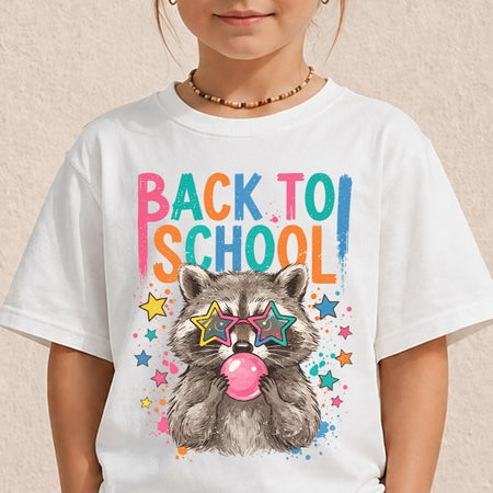 A child wearing a white t-shirt printed with a cute raccoon wearing colorful star sunglasses and blowing pink bubblegum beneath vibrant "BACK TO SCHOOL" lettering.