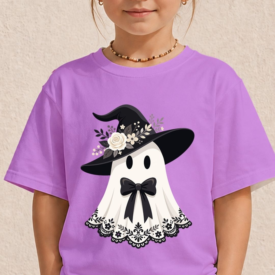 Child wearing a pastel purple t-shirt with a cute ghost wearing a floral witch hat and a black bow.