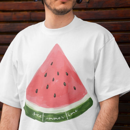 Close up of a man wearing a white oversized t-shirt showing a hand-drawn watermelon sublimation print with green rind detail and summer typography.