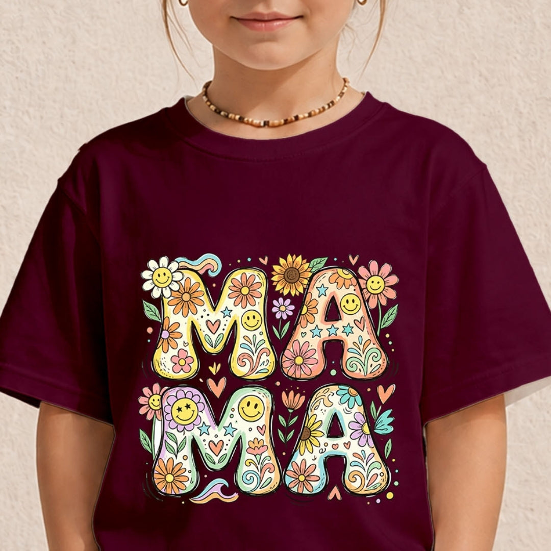 Close-up of a child wearing a dark maroon t-shirt printed with a colorful vintage psychedelic "MAMA" floral typography design.