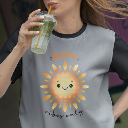 Person wearing a t-shirt with a sun graphic and 'Summer vibes only' text, holding a drink.