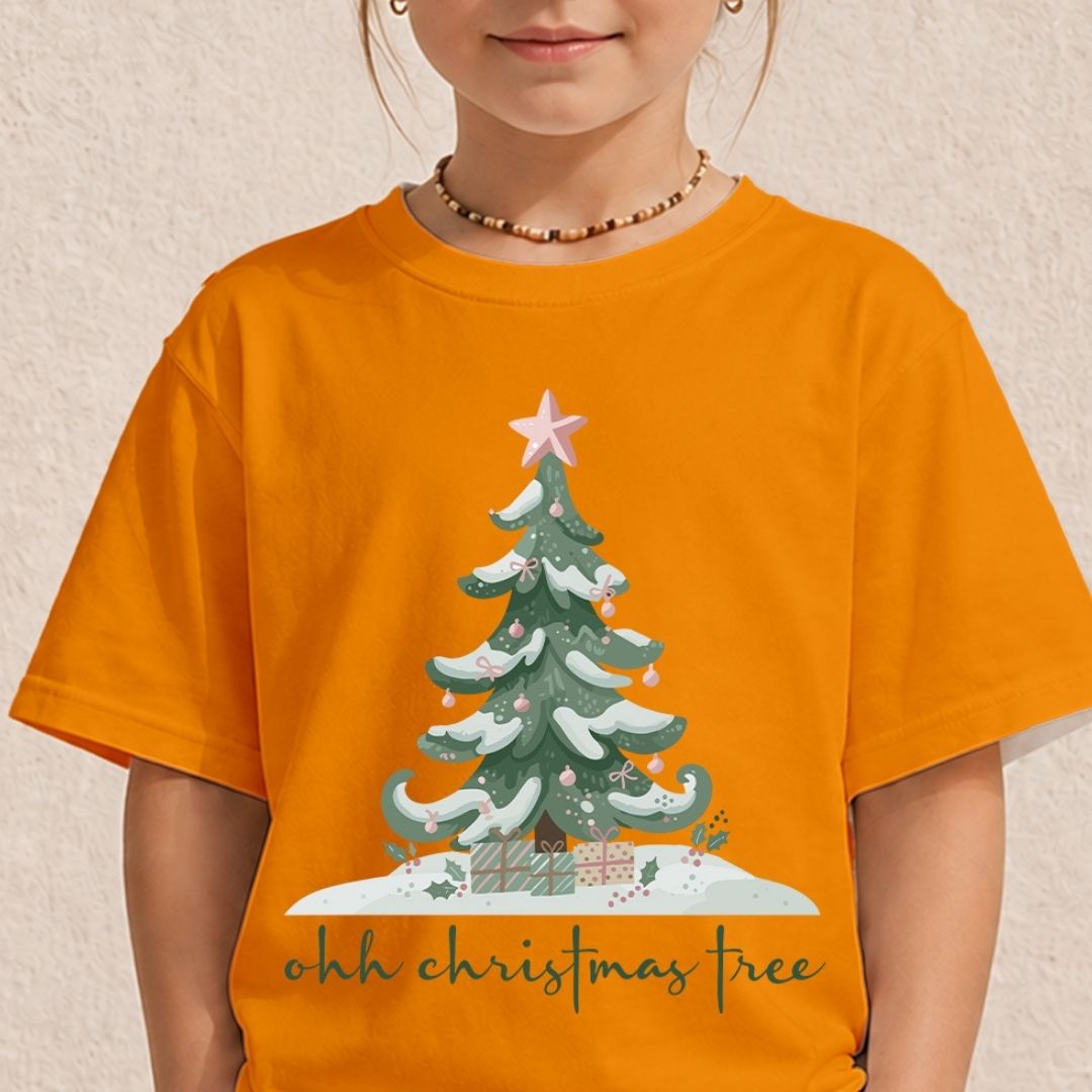 Child wearing an orange t-shirt showcasing a vibrant "ohh christmas tree" holiday graphic print with presents and a pink star.