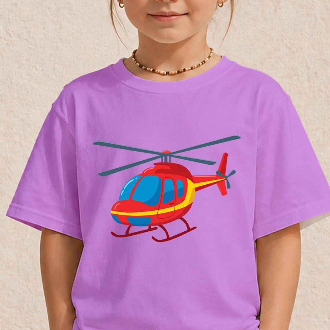 A child wearing a lavender purple t-shirt with a colorful cartoon helicopter graphic on the front, set against a textured beige wall.