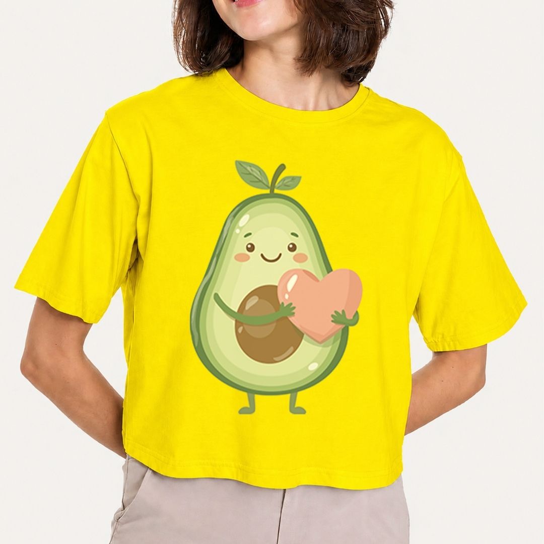 Person wearing a yellow t-shirt with an avocado character holding a heart.