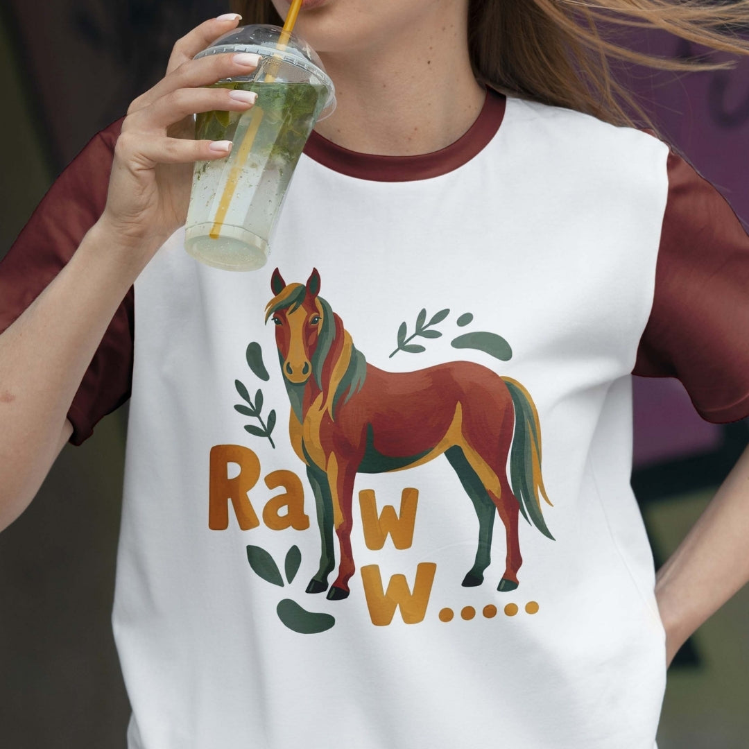 Person wearing a t-shirt with a horse graphic and 'Raww' text, holding a drink.