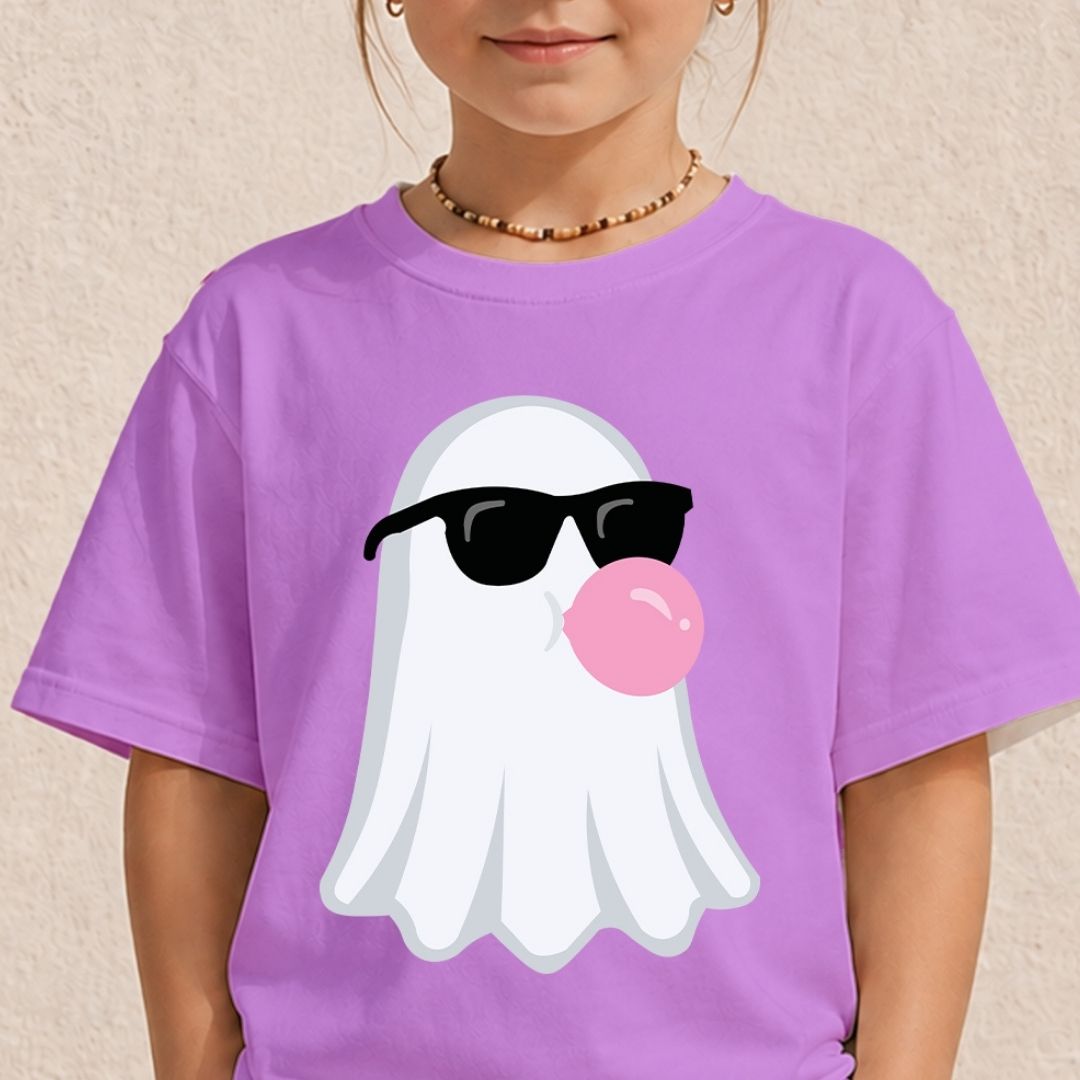 A child wearing a purple short-sleeve T-shirt with a cartoon ghost graphic wearing black sunglasses and blowing a pink bubblegum bubble.