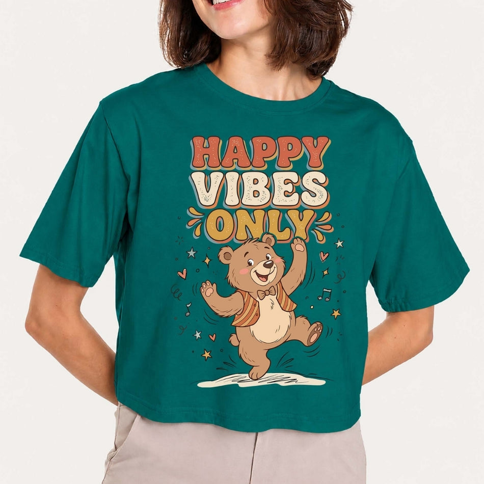 Person wearing a teal t-shirt with a bear graphic and 'Happy Vibes Only' text.