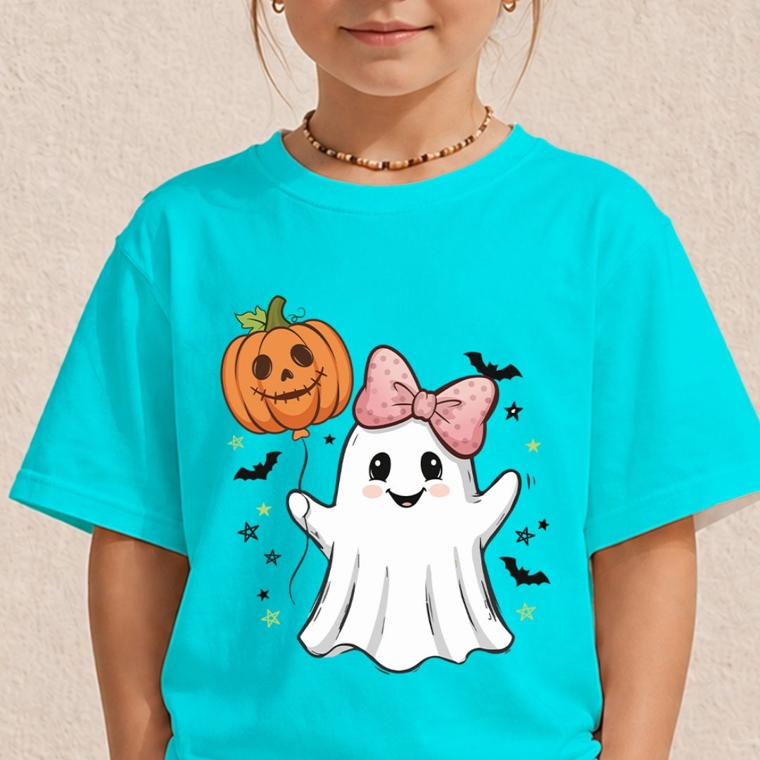 A child wearing a bright turquoise short-sleeve T-shirt with a cute Halloween graphic featuring a white ghost with a pink bow, an orange jack-o'-lantern balloon, and small black bats and stars.