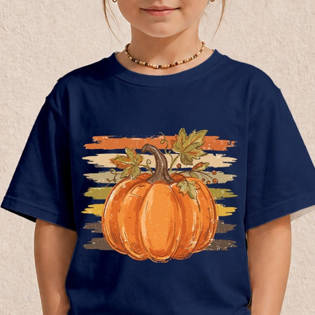 A child wearing a navy blue short-sleeve t-shirt with a graphic of a large orange pumpkin and autumn leaves against a distressed sunset stripe background.