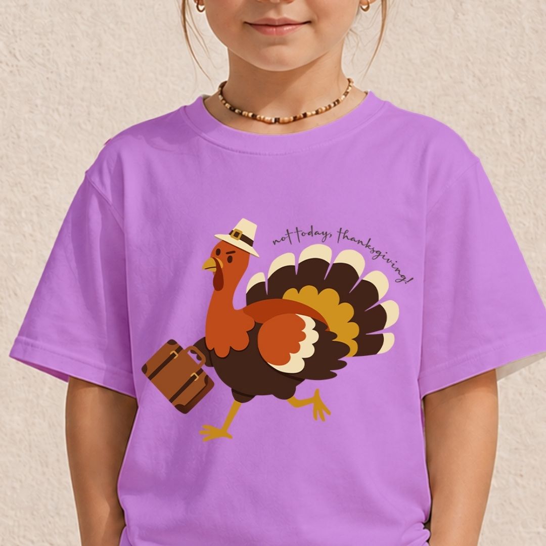 A child wearing a purple short-sleeve t-shirt with a cartoon turkey graphic carrying a suitcase and the text 'met today, thanksgiving!'.