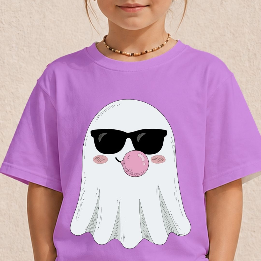 Young girl wearing a light purple t-shirt printed with a cute Halloween ghost graphic wearing sunglasses blowing a pink bubble.