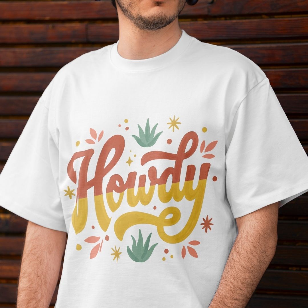 Close up of a man wearing a casual white t-shirt showing a large retro "Howdy" typography sublimation print on the front.