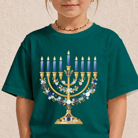 A child wearing a dark teal green t-shirt with a large graphic of a gold menorah adorned with blue and white flowers and lit blue candles.