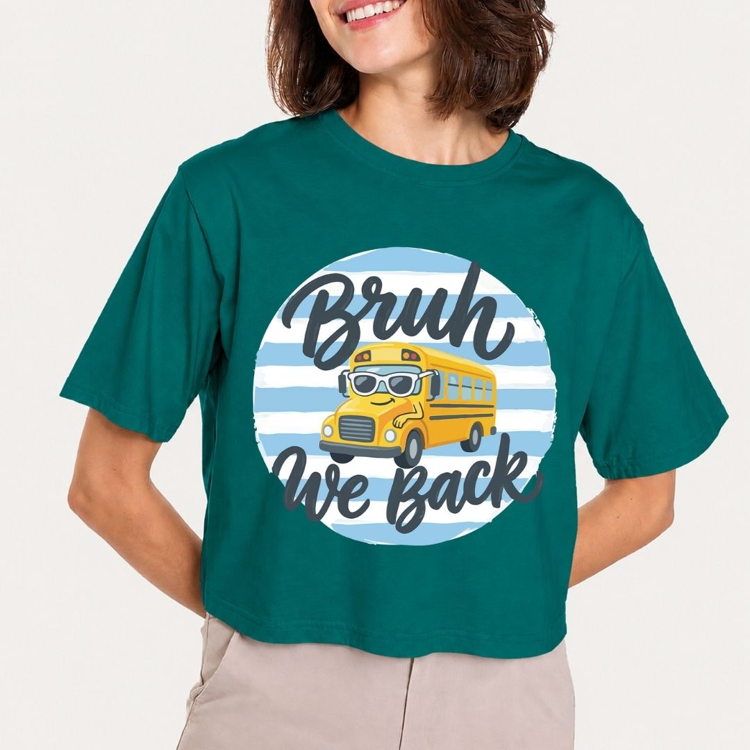Person wearing a teal t-shirt with a graphic of a school bus and text on a plain background