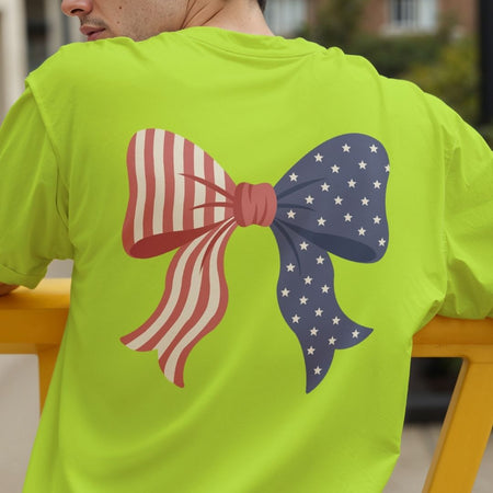 Rear view of a man wearing a bright lime green t-shirt showing a large American flag ribbon bow sublimation print on the back.