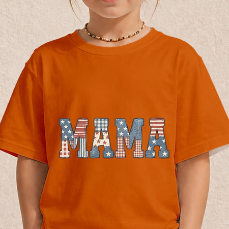 Close-up of a child wearing a bright orange crewneck t-shirt printed with a rustic patriotic "MAMA" text design featuring American flag pattern fillings.