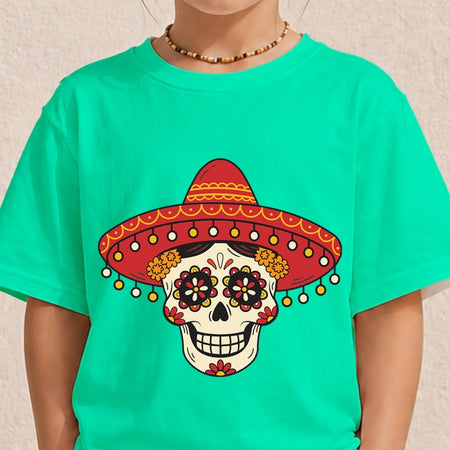 A person wearing a bright turquoise T-shirt with a large Day of the Dead sugar skull graphic wearing a red sombrero on the front, against a light textured wall.